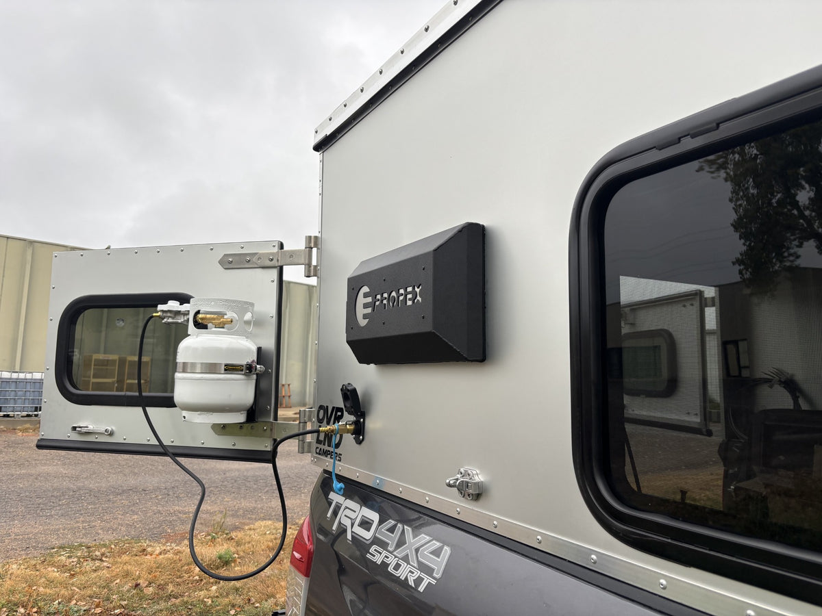 Propex HS2000 wall mount kit exterior cover and propane bottle on a truck topper